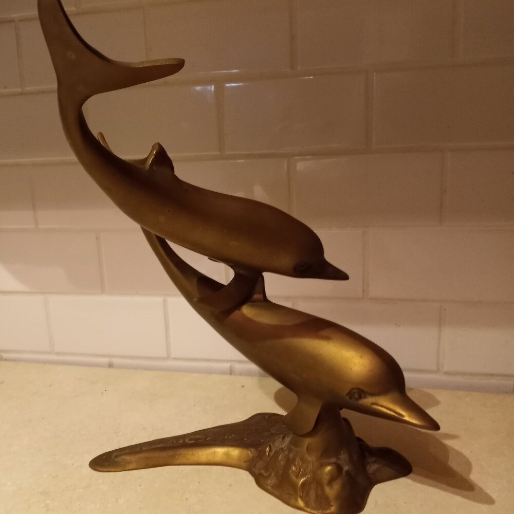 Brass dolphin structure